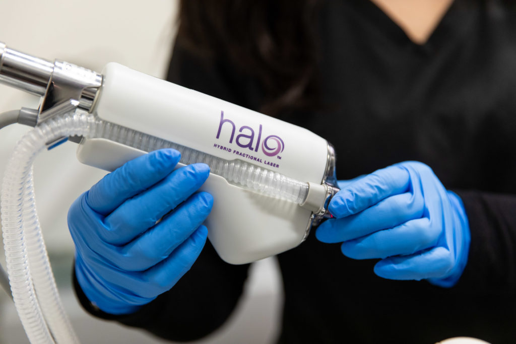 A clinician holding the HALO handpiece in a treatment room