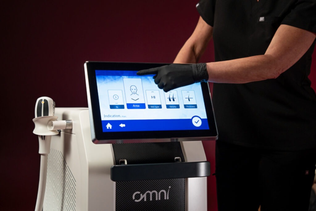 A clinician selecting a preset on the OMNI touchscreen interface